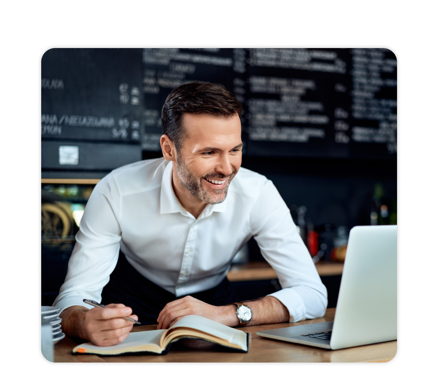 Restaurant owner updating their menu on a laptop